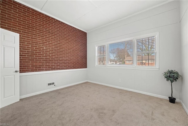 empty room with crown molding and light carpet