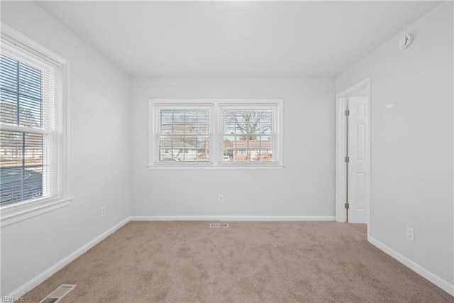 carpeted spare room with a healthy amount of sunlight