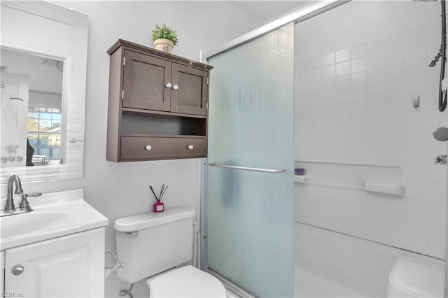 full bathroom featuring shower / bath combination with glass door, vanity, and toilet