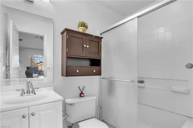 full bathroom with vanity, tiled shower / bath combo, and toilet