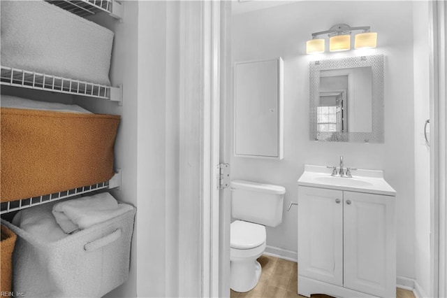 bathroom with vanity, hardwood / wood-style flooring, and toilet