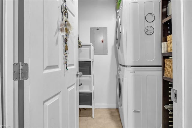 laundry area with stacked washing maching and dryer and electric panel