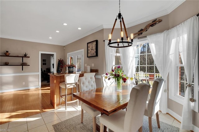 dining room with a notable chandelier, crown molding, light tile patterned floors, recessed lighting, and baseboards