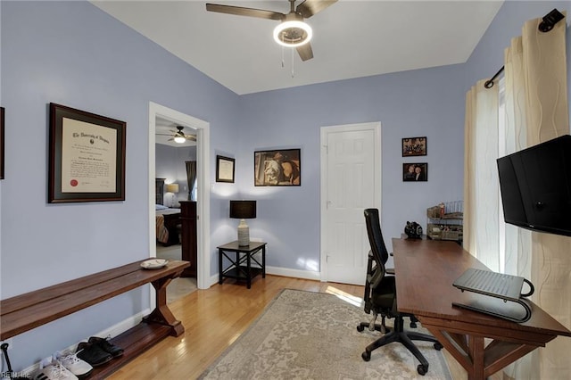 office with light wood-type flooring, ceiling fan, and baseboards