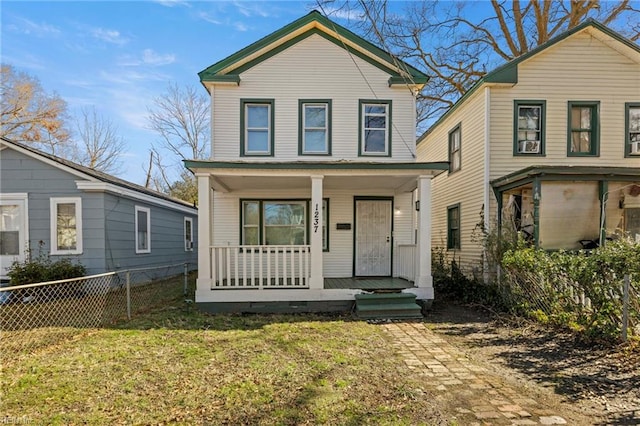 view of front property featuring covered porch and a front lawn