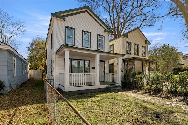 view of front of house with covered porch and a front yard