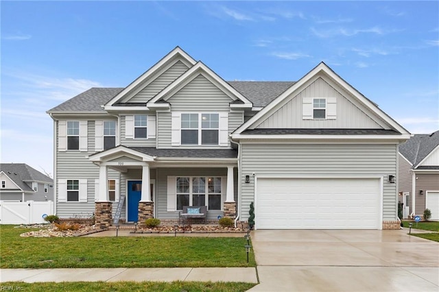 craftsman house with a garage, a front lawn, and covered porch