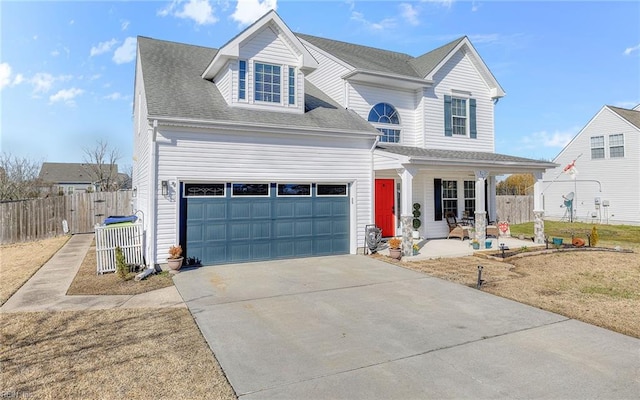 traditional home with driveway, a shingled roof, an attached garage, fence, and a porch