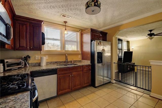 kitchen featuring sink, crown molding, stainless steel appliances, light stone countertops, and a textured ceiling