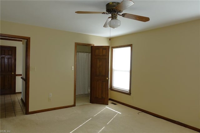 unfurnished bedroom with light carpet and ceiling fan