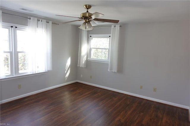 empty room featuring ceiling fan and dark hardwood / wood-style flooring