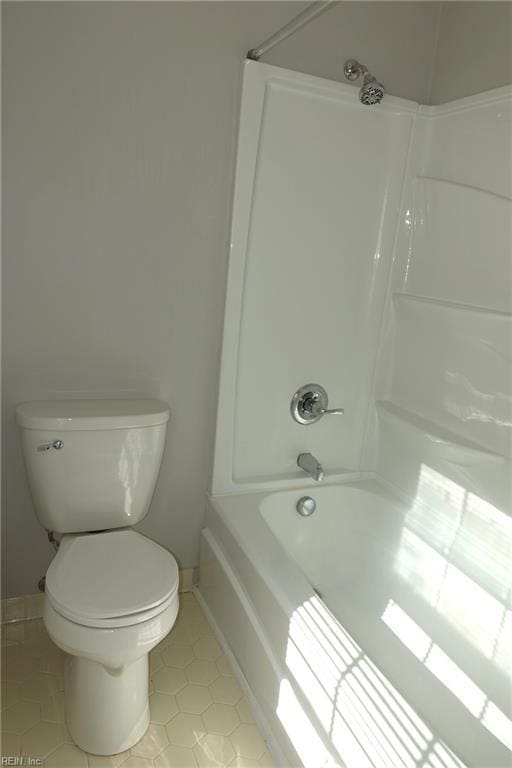 bathroom featuring tile patterned floors, toilet, and shower / tub combination