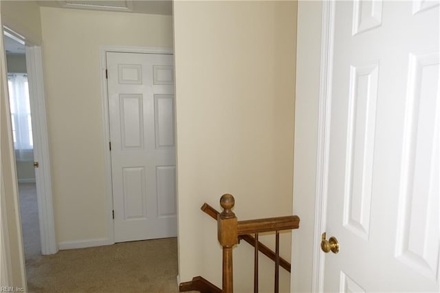 hallway featuring light colored carpet