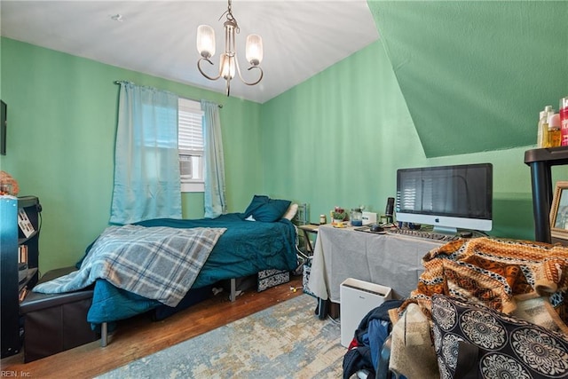 bedroom featuring wood-type flooring and a chandelier