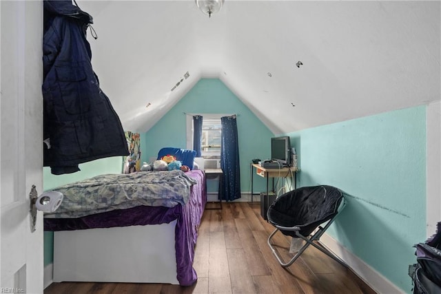 bedroom featuring lofted ceiling and wood-type flooring