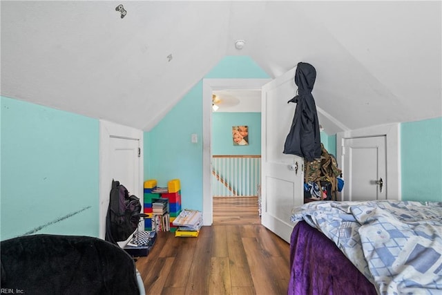 bedroom with lofted ceiling, hardwood / wood-style floors, and a closet