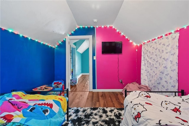 bedroom featuring wood-type flooring and vaulted ceiling