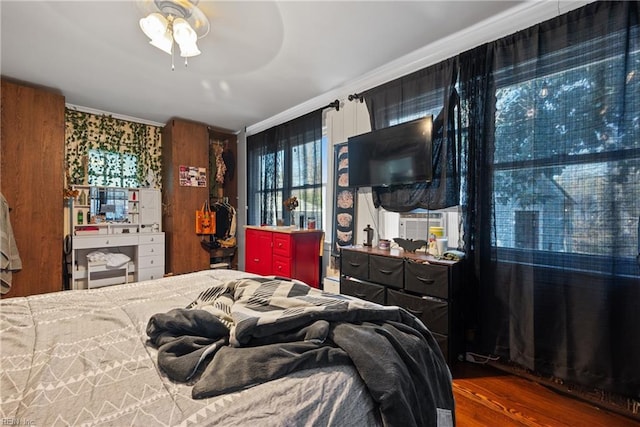 bedroom with dark hardwood / wood-style floors and ceiling fan