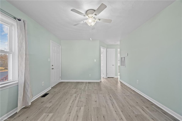 empty room featuring ceiling fan and light hardwood / wood-style floors