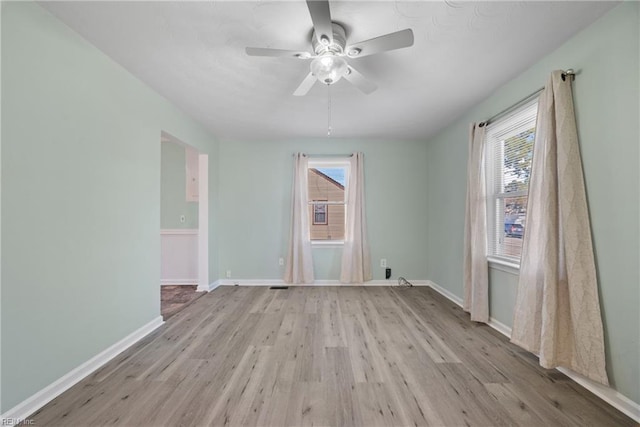 spare room featuring light wood-type flooring and ceiling fan