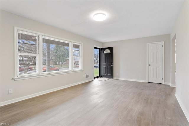 empty room with light hardwood / wood-style floors