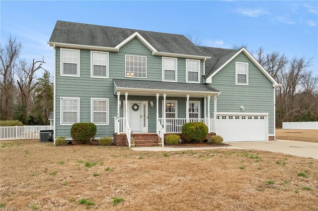 colonial-style house featuring central air condition unit, an attached garage, a front yard, fence, and driveway