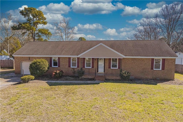 ranch-style home featuring a front lawn and a garage