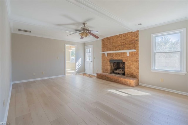 unfurnished living room featuring ornamental molding, light hardwood / wood-style flooring, and a wealth of natural light