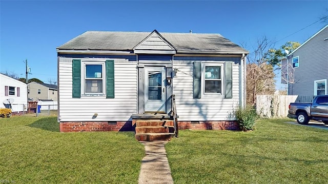 bungalow featuring entry steps, crawl space, and a front lawn