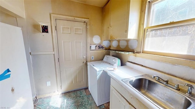 laundry area with a sink and washer and clothes dryer