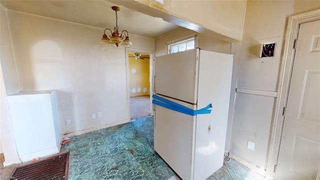 kitchen with a ceiling fan, freestanding refrigerator, and tile patterned floors