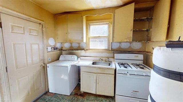 kitchen with washer / dryer, light countertops, a sink, and gas range gas stove