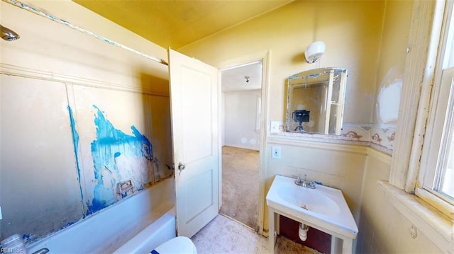 bathroom featuring a sink and a washtub