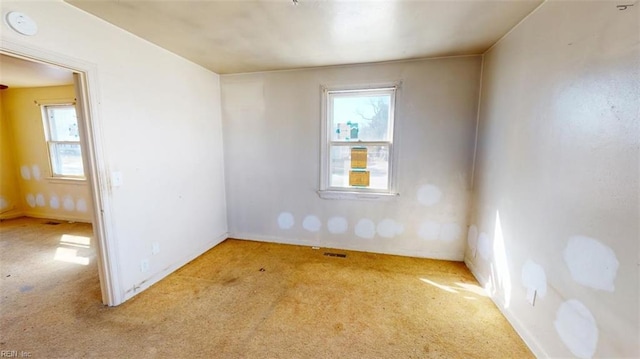 spare room with light carpet and visible vents