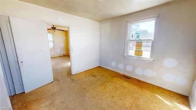 unfurnished room featuring visible vents and light colored carpet