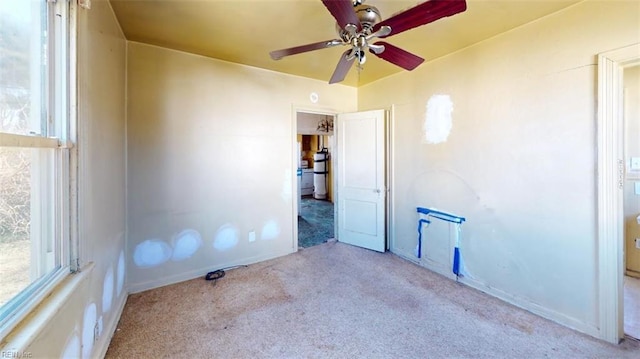 unfurnished room with light carpet and ceiling fan