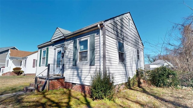 view of home's exterior featuring crawl space and a yard