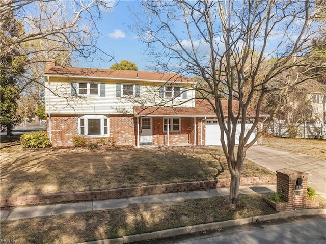 view of front of property featuring an attached garage, brick siding, driveway, a chimney, and a front yard