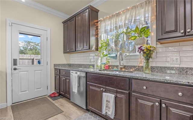 kitchen with dark brown cabinets, stainless steel dishwasher, a sink, crown molding, and light wood-style flooring