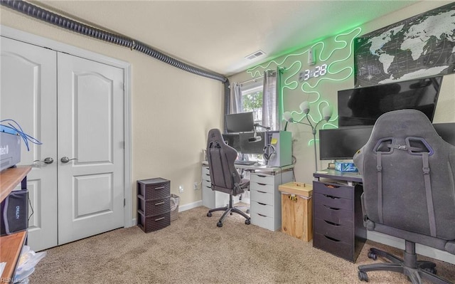 carpeted office featuring visible vents and baseboards