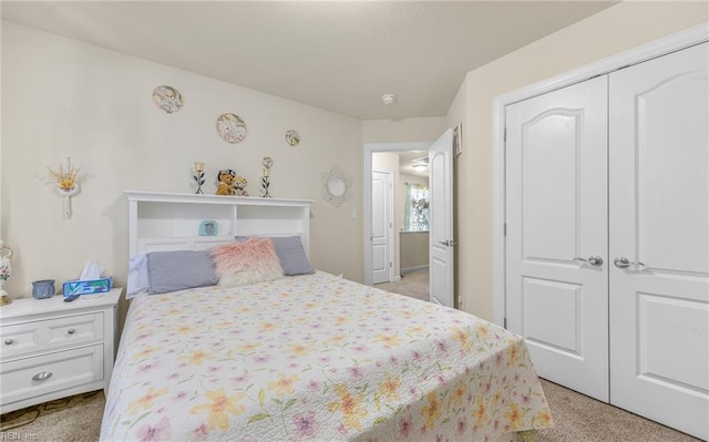bedroom with light carpet and a closet