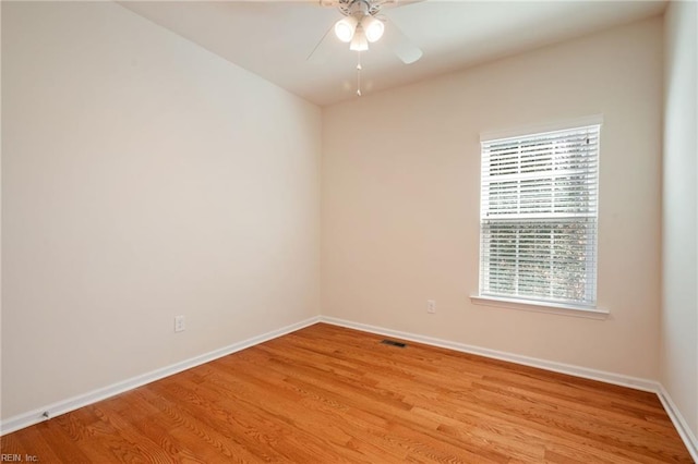 spare room with light wood-type flooring and ceiling fan