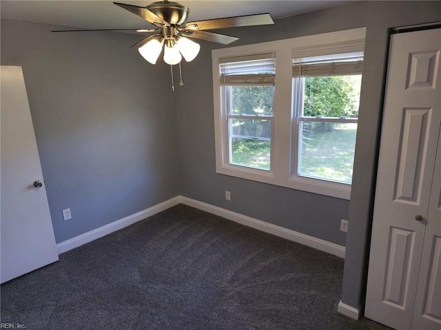 carpeted spare room featuring ceiling fan