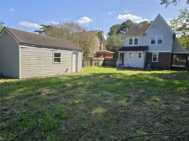 back of house featuring an outdoor structure and a lawn