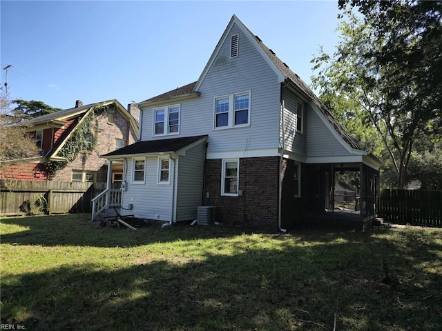 back of house with cooling unit, a sunroom, and a lawn