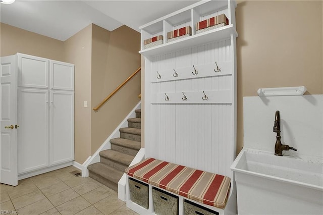 mudroom with sink and light tile patterned floors