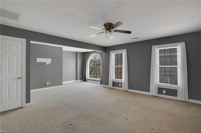 carpeted spare room with ceiling fan