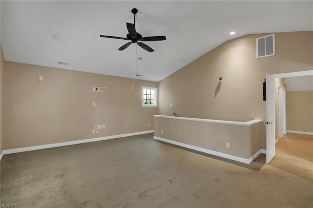 unfurnished room with carpet floors, vaulted ceiling, and ceiling fan