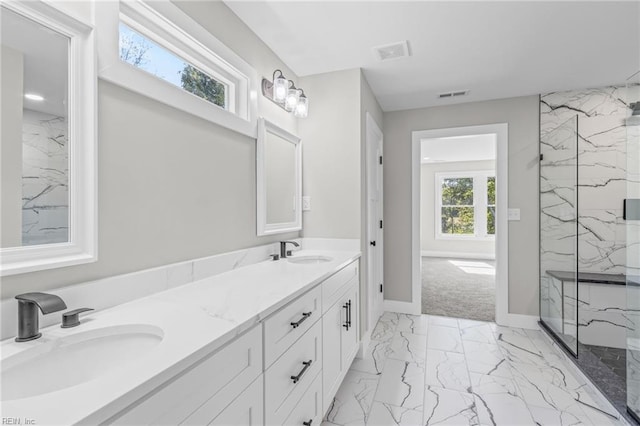 full bathroom featuring double vanity, marble finish floor, visible vents, and a sink