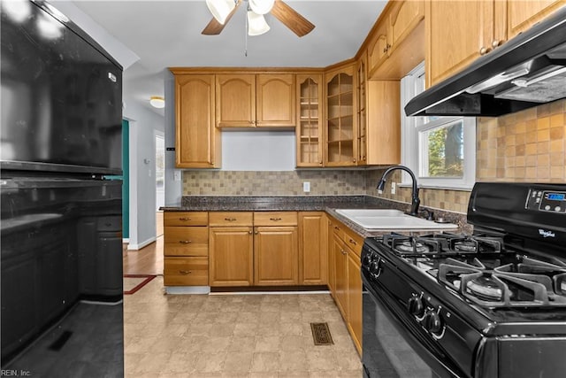 kitchen featuring sink, extractor fan, decorative backsplash, and black gas range oven